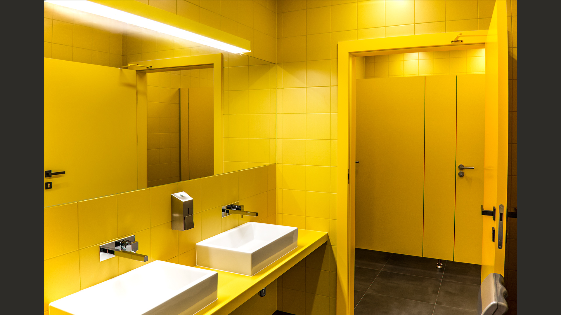 Prosty zabieg konsekwentnego użycia jednego koloru sprawił, że – przy niewielkim budżecie realizacyjnym – powstało bardzo wyraziste wnętrze. Na zdjęciu – damskie toalety.