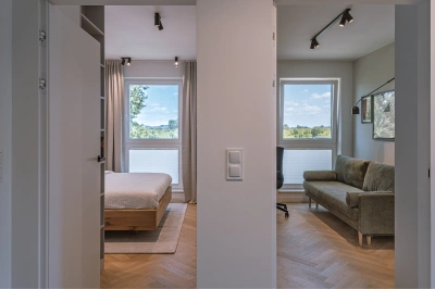 Projekt minimalistycznego wnętrza na Mokotowie w stylistyce nawiązującej do lat 60tych &ndash; dyskretne drzwi do sypialni i gabinetu